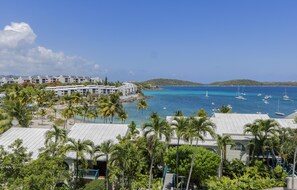 A coastal resort with multiple white buildings, a beach, and a marina with sailboats. - New High End Rental At Cowpet Bay! Amazing Views/Breezes! (East End)