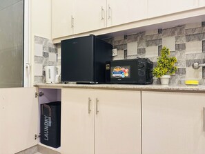 Fridge, microwave, electric kettle, cookware/dishes/utensils
