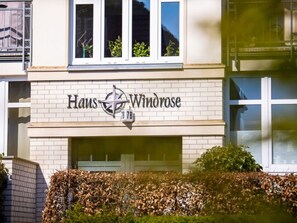 A building with the sign "Haus Windrose" and the number "18" indicating its address.