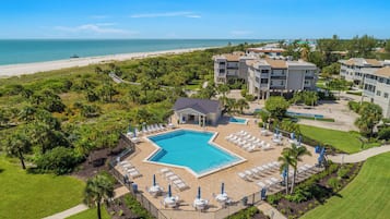 A resort with a swimming pool, beach access, and multiple buildings.