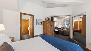 Ein Hotelzimmer mit einem Bett, einem Holzschrank, einer Couch und einem Spiegel.