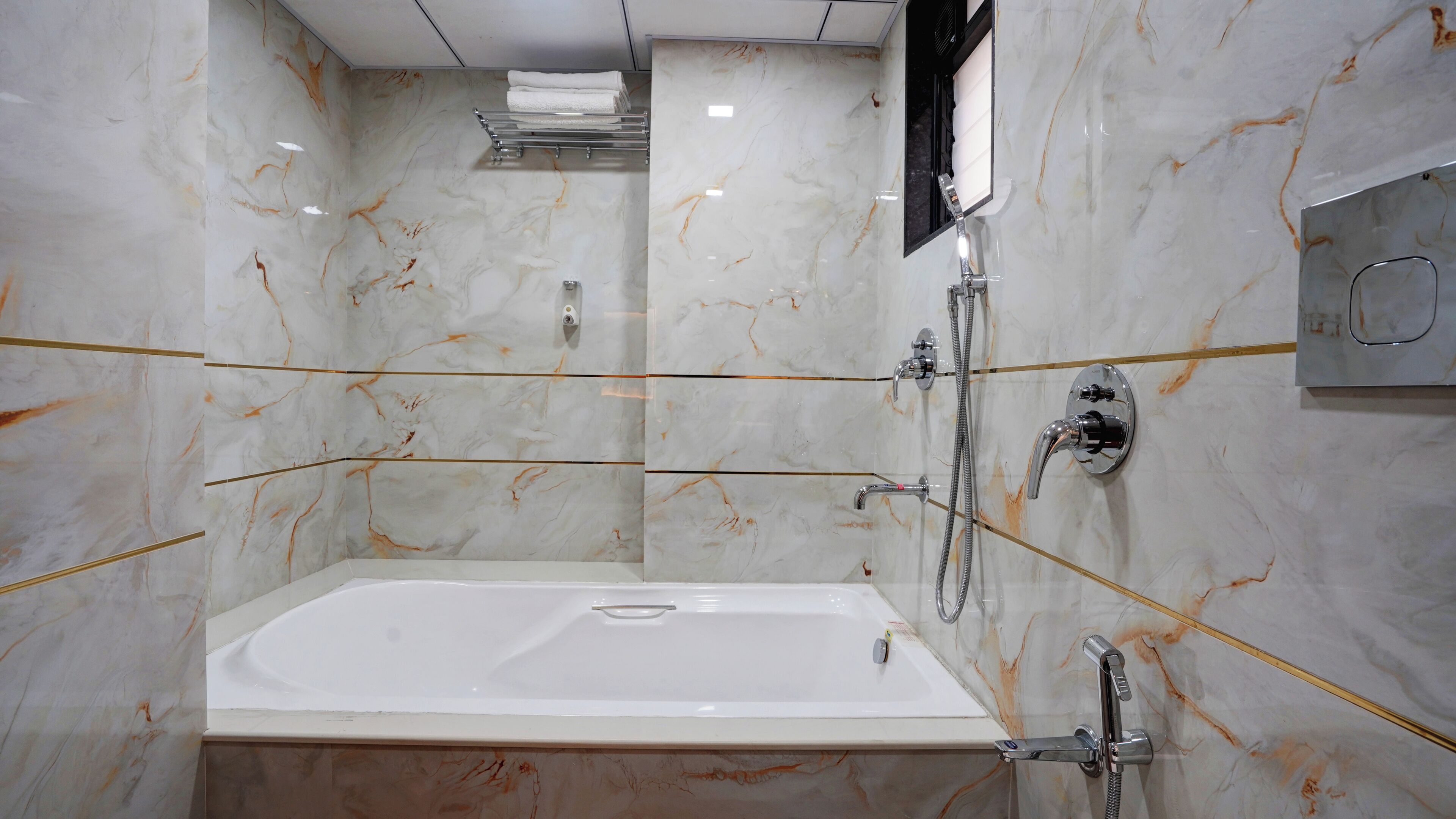 A modern bathroom with a marble vanity, a bathtub, and a shower area.