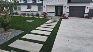 A modern house with a stone facade, a garage, and a well-maintained lawn with stepping stones. - Scottsdale Oldtown Paradise - New Home with 4 bedrooms and 3 bath (Scottsdale)