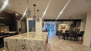 A modern kitchen with granite countertops, stainless steel appliances, and pendant lighting. - Scottsdale Oldtown Paradise - New Home with 4 bedrooms and 3 bath (Scottsdale)