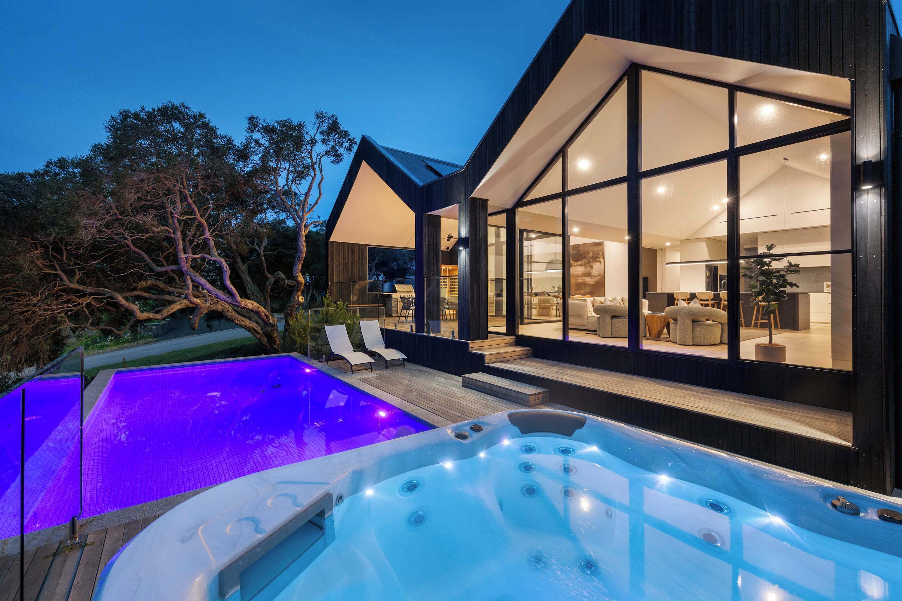 A modern house with a swimming pool and hot tub.