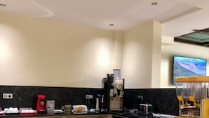 A modern kitchen with a black countertop, wooden cabinets, and a marble backsplash. - Star Inn Hotel Aeroport (Algiers)