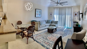 A modern living room with a sofa, coffee table, and dining area. - Grand Champions Villas in Wailea, Maui (Kihei)