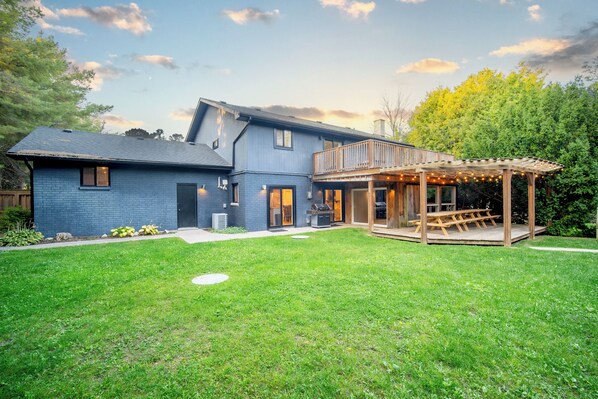 A two-story house with a covered patio area.