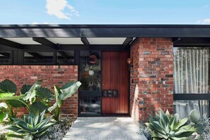 A modern house with a brick facade, a wooden door, and large windows. - Luxurious Mid-Century Modern Home, Yarra Valley (Healesville)