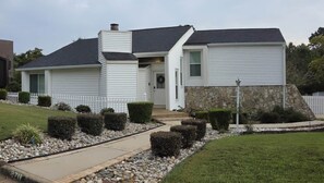 A single-story house with a stone foundation, a front porch, and a pathway leading to the entrance. - Premium 3 BR, Private Pool, Paid Utiliities, Sleeps 6 (Augusta)
