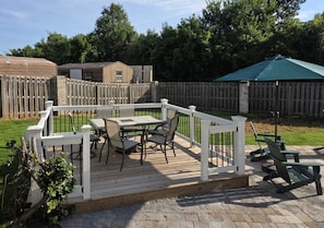 A deck with outdoor furniture, a wooden fence, and a green umbrella. - Premium 3 BR, Private Pool, Paid Utiliities, Sleeps 6 (Augusta)