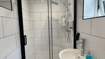 Shower, hair dryer, towels, toilet paper