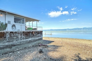 Un bâtiment situé au bord de l’eau, doté d’une zone abritée et offrant une vue sur l’eau.