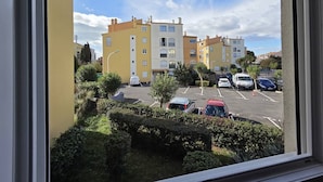 A view of a parking lot with several cars, a building with multiple floors, and a clear sky. - Lovely 2-room apartment for 4 people in Mt St Martin near the port of Cap d'Agde (LE CAP D AGDE)