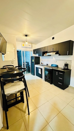 Coffee/tea maker, cookware/dishes/utensils, dining tables. Sasha's House