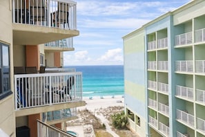 A multi-story hotel with balconies overlooking a beach. - *Heart of Orange Beach - Gulf front*Pool*Balcony (Orange Beach)
