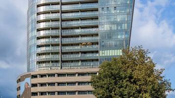 A modern high-rise building with a glass facade, labeled 'HANZA TOWER.'