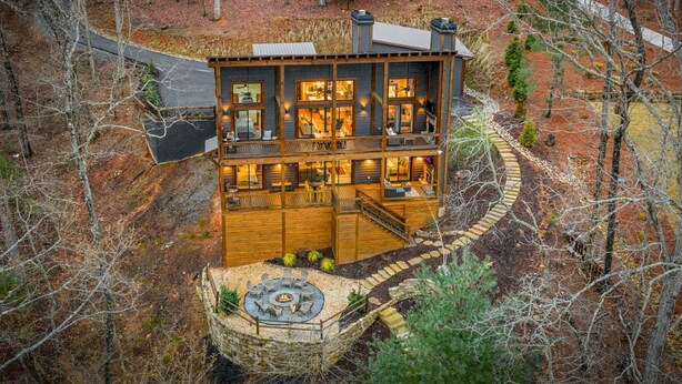 A multi-level wooden cabin with a fireplace, outdoor seating, and a stone pathway. - Blue Ridge Retreat - Lakefront | Dock | Firepit | Game Room (Blue Ridge)