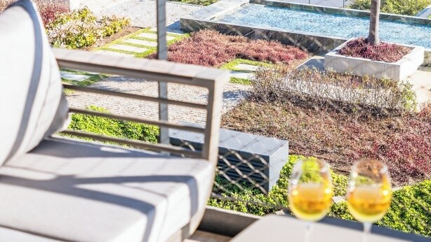 A terrace with a view of the ocean, a dining table with food and drinks, and a lounge chair. - III - Savoy Monumentalis, By Pausa Holiday Rentals (Funchal)
