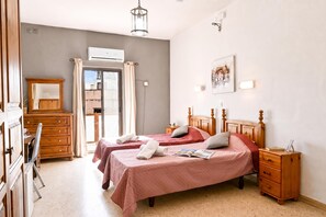 A bedroom with two beds, a wooden dresser, a desk, and a window with curtains. - Sefranda Near St.Julian's Ensuite Room 5, San Gwann, Malta (San Gwann)