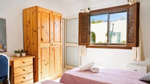 A bedroom with two beds, wooden wardrobe, a desk, and a window with shutters. - Sefranda Near St.Julian's Ensuite Room 3, San Gwann, Malta (San Gwann)