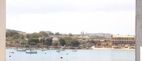 A harbor with boats and a building labeled "ANGEL ISLAND YACHT YARD".
