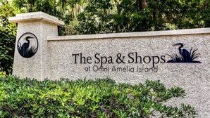 A sign for "The Spa & Shops at Omni Amelia Island" with a logo of a heron. - Oceanview 3BR Condo - Beautiful Pool on Amelia Island (Fernandina Beach)