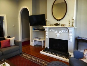 A living room with a fireplace, a television, and a sofa.