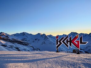 Paisaje nevado de montaña con un cartel que dice "BAGGL".