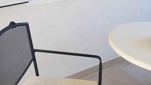 A room with a bed, a small table, and a chair. - Holiday Apartment Mandarin (Sv. Filip i Jakov)