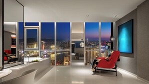 A modern hotel room with a city view, a red chair, a large TV, and a bathroom with a mirror. - SEYA Panoramic Hotel - Chongqing Cloud Eye - Managed by SEYA GROUP (Chongqing)