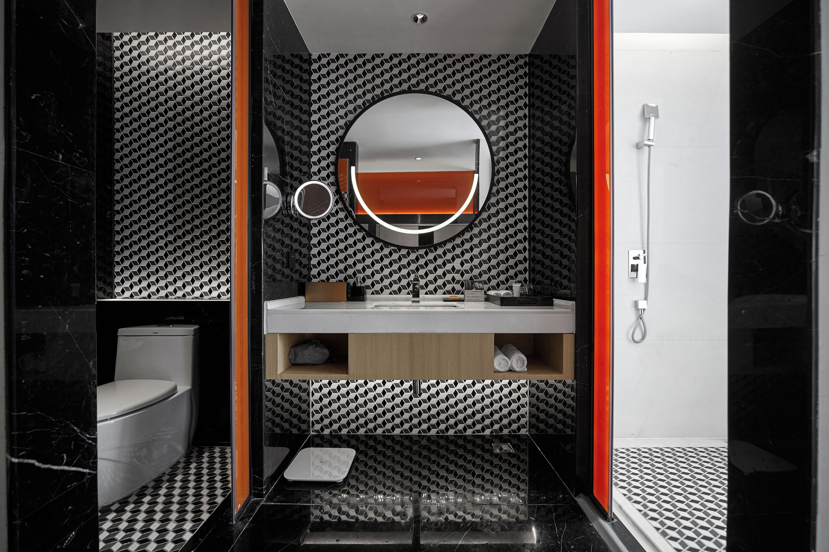 Un baño moderno con inodoro, lavamanos, espejo y ducha.