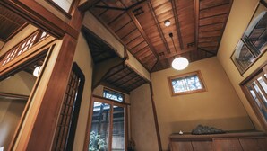 A traditional interior with wooden beams, a skylight, and a small window. - NIPPONIA Niigata Furumachi Kagai (Niigata)