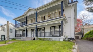 A two-story house with a front porch, a balcony on the second floor, and a garage. - 8 Mi to Micron Technology! Walkable Phoenix Gem (Phoenix)