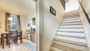 A staircase with wooden steps and a handrail, leading to an upper floor. - Gateway to Adventure! Dtwn Toledo Home Near Hiking (Toledo)