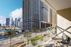A high-rise building with a view of a marina and city skyline. - LUX The Grand Bleu Suite (Dubai)