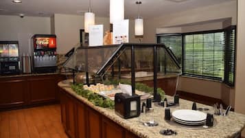 Breakfast serving counter with glass display case and beverage station
