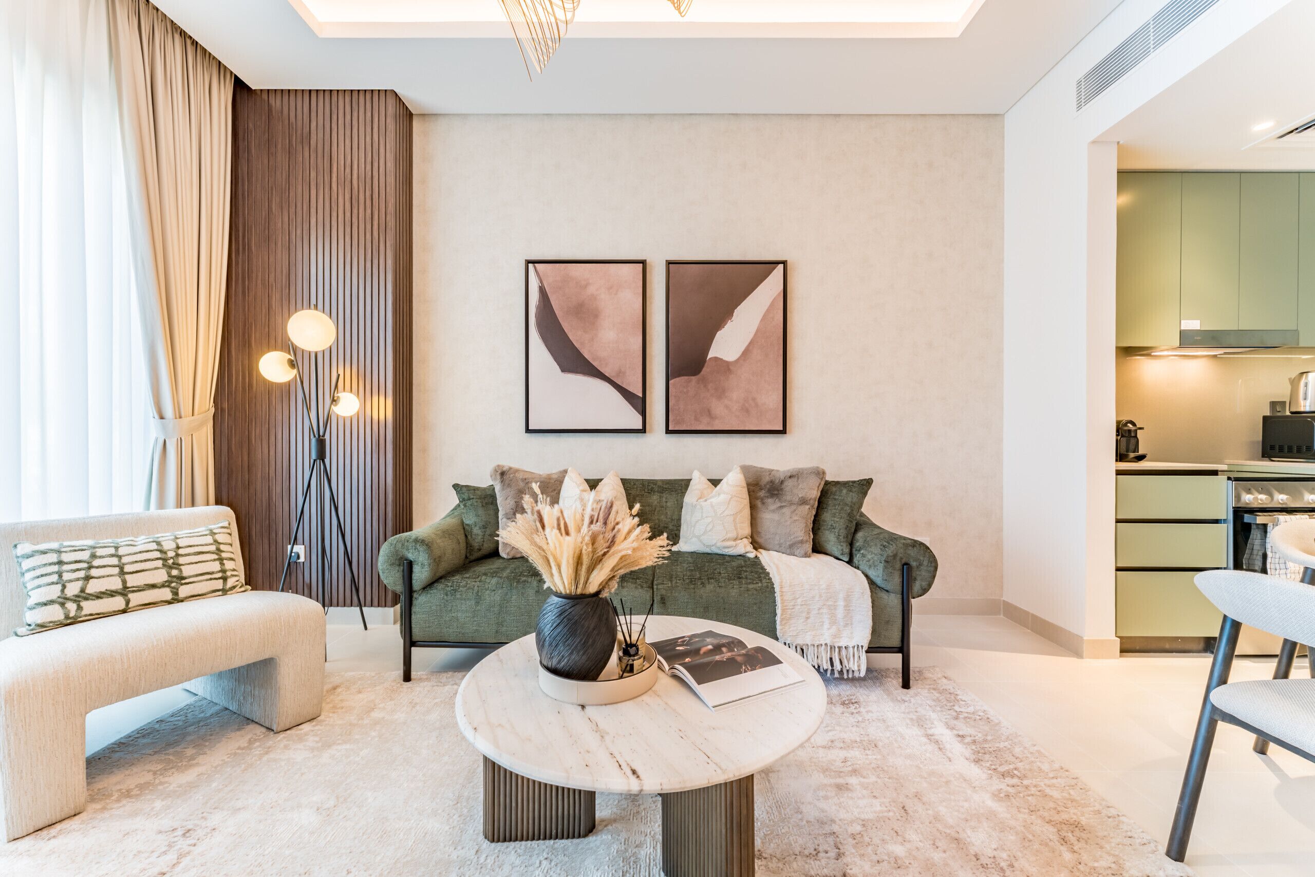 A modern living room with a sofa, a coffee table, and a dining area.