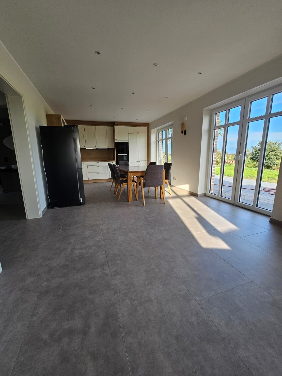 A spacious kitchen with modern appliances and a dining area with a table and chairs.