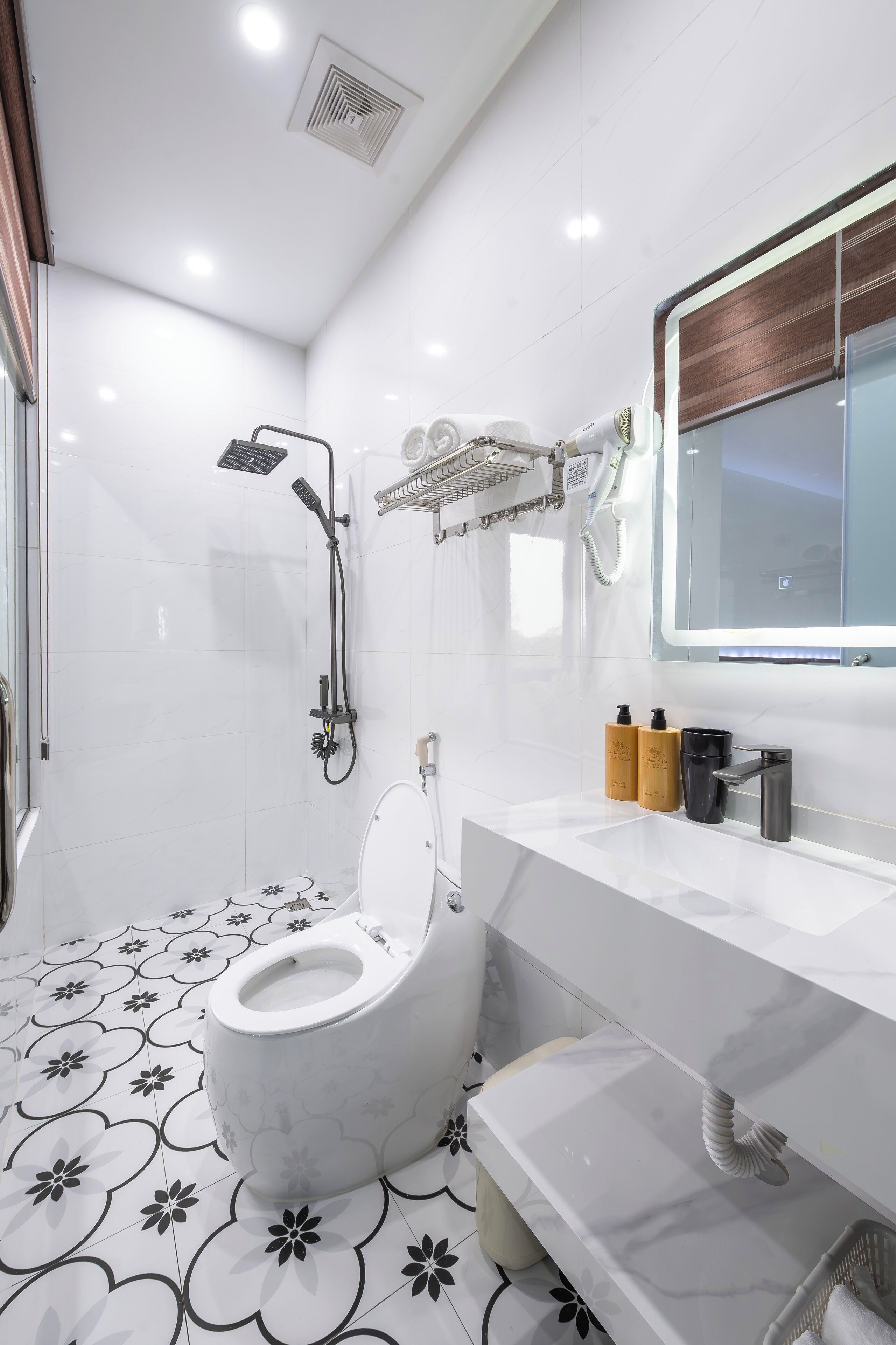 A modern bathroom with a toilet, shower, and vanity.