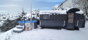 A snow-covered outdoor area with a hot tub, a small cabin-like structure, and a shed. - Hiking & Wellness · Sauna, Hot Tub, Fireplace (Winterberg)