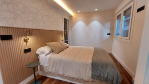 Una camera da letto moderna con un letto, un comodino e una finestra.