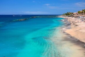 A beach with clear turquoise waters, a sandy shore, and a pier extending into the sea. - Sunny Apartment for 4 in Vera (Arona)
