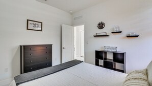 Ein Schlafzimmer mit Bett, Schminktisch und Regalen mit Schildern.