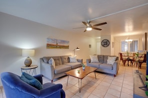 A living room with two sofas, a coffee table, a lamp, and a ceiling fan. - Walk to Waterfront! Couples Retreat in Old Town (Scottsdale)