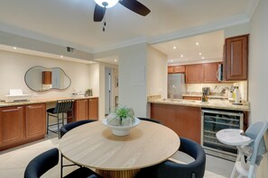 A modern kitchen with wooden cabinets, a built-in oven, and a refrigerator. - Easy Living in Old Town: Condo w/ Pool Access! (Scottsdale)