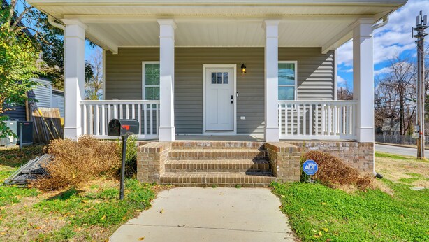 A two-story house with a front porch, a mailbox, and a street sign. - 1 Mi to Downtown Greensboro: Newly Built Home! (Greensboro)
