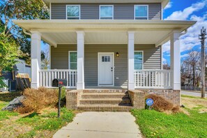 A two-story house with a front porch, a mailbox, and a street sign. - 1 Mi to Downtown Greensboro: Newly Built Home! (Greensboro)