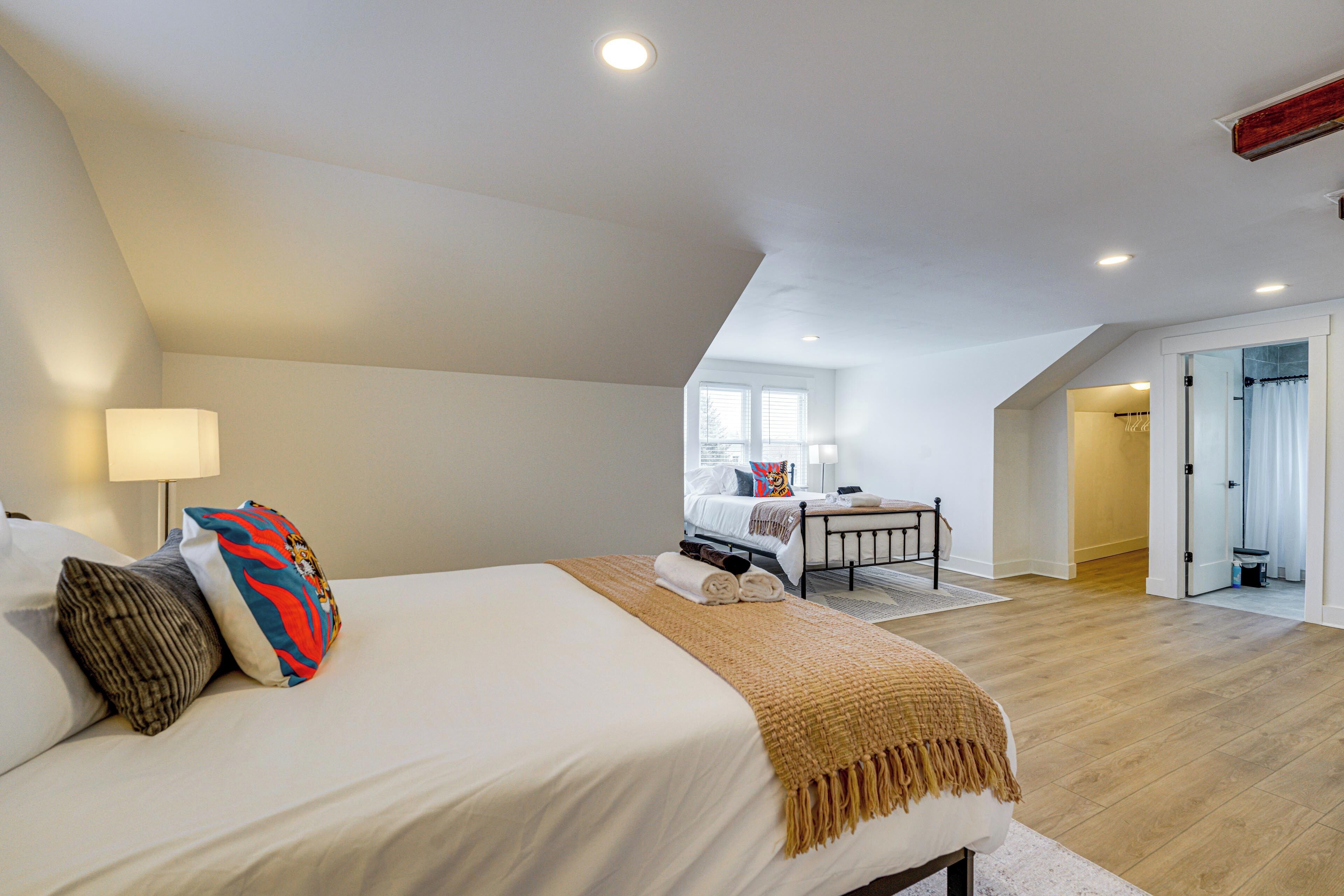 A bedroom with a large bed, a bedside table, and a window.