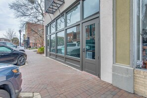 A building with large windows and a brick-paved sidewalk. - Walk to Shops & Restaurants! Dtwn Florence Unit (Florence)